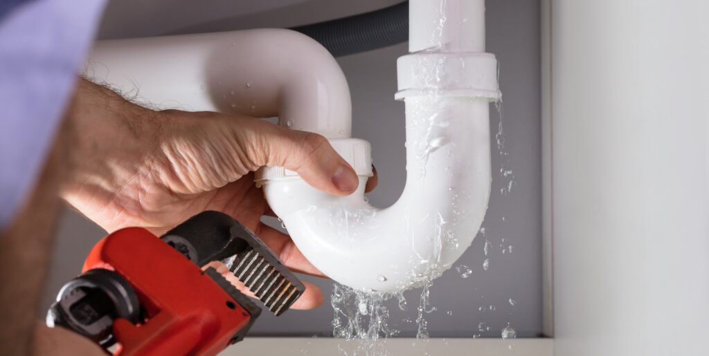 Licensed plumber repairing a pipe