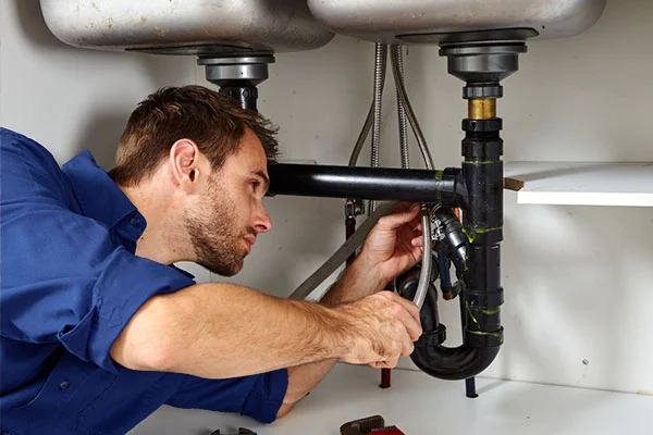 Plumber repairing burst pipe